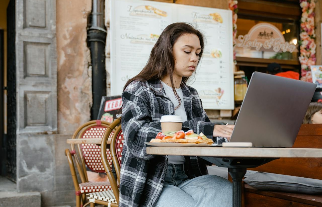Cafe owner working on a laptop at a table