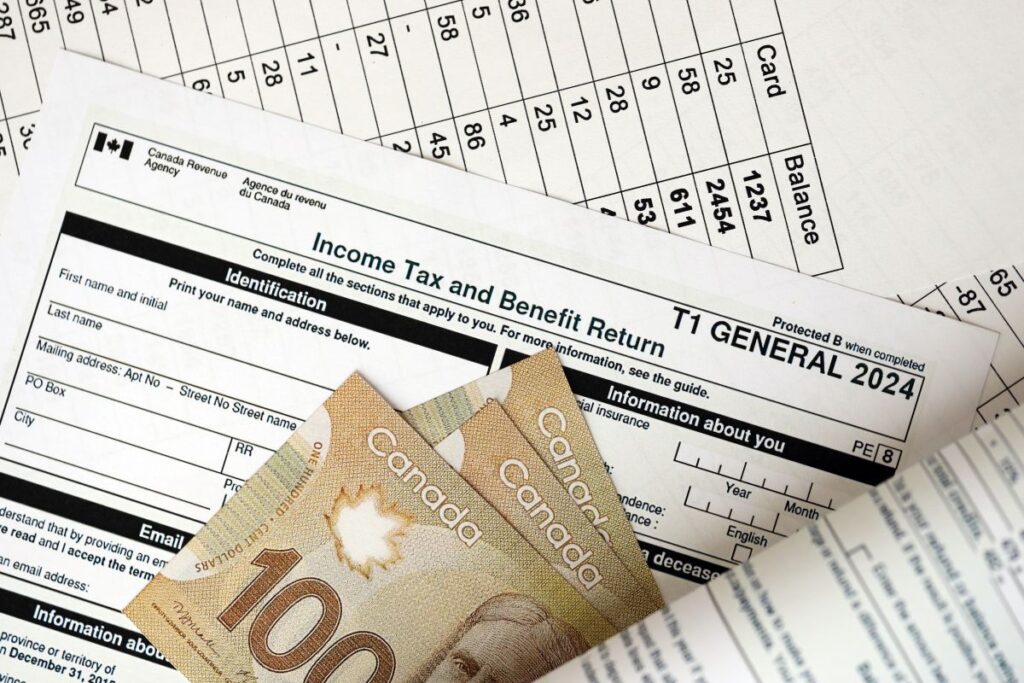 Canadian T1 General tax return with $100 bills on top