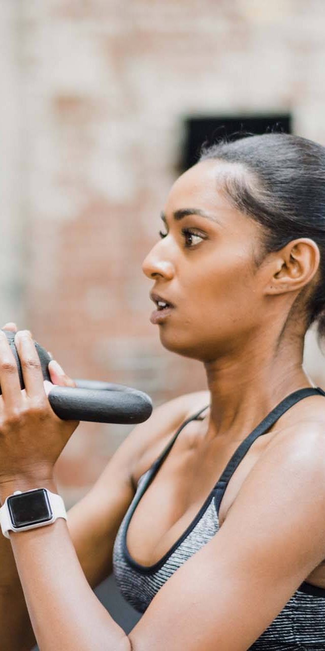 Fitness Trainer at Work Fitness trainer holding a dumbbell during a session